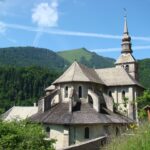 Chevet de l'église abbatiale d'Abondance et son clocher, face aux montagnes du Chablais